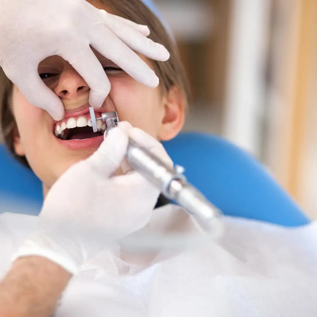 a patient is getting their teeth exam and clean by a dentist