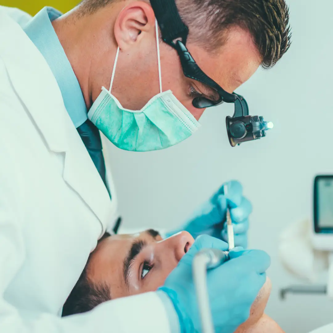 a patient in Sherman TX Clinic is getting their teeth checked by a dentist and assistant